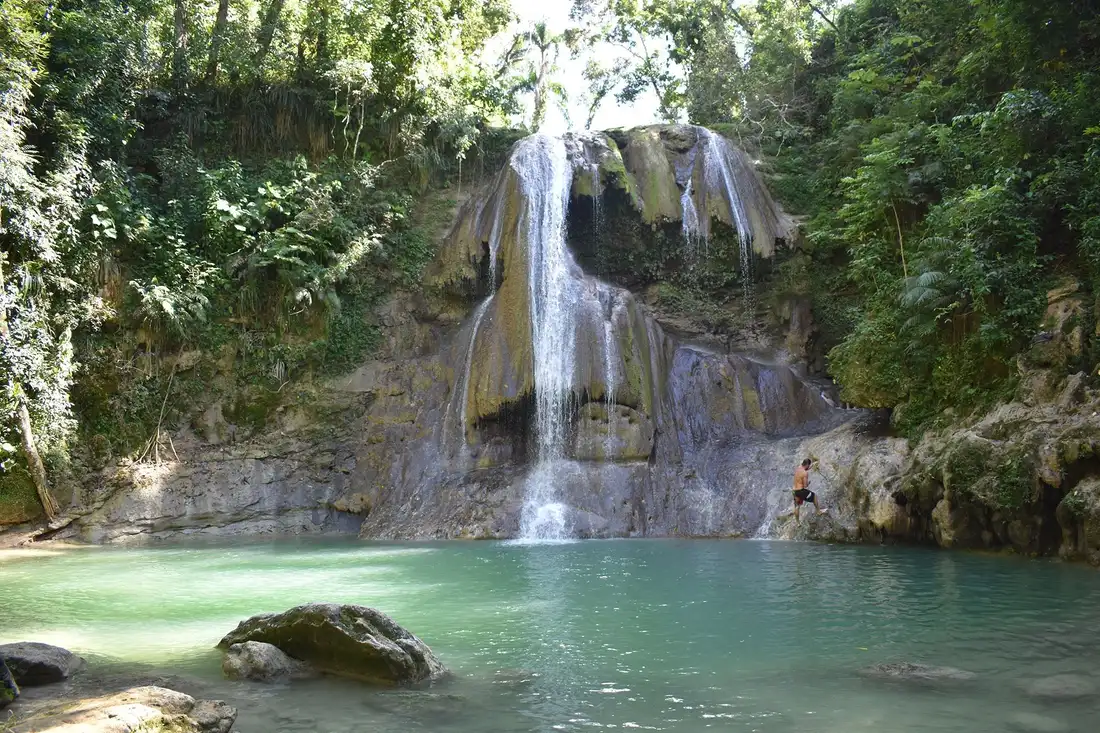 Lower cascade and crystal clear natural swimming pool at Gozalandia Waterfall in Puerto Rico