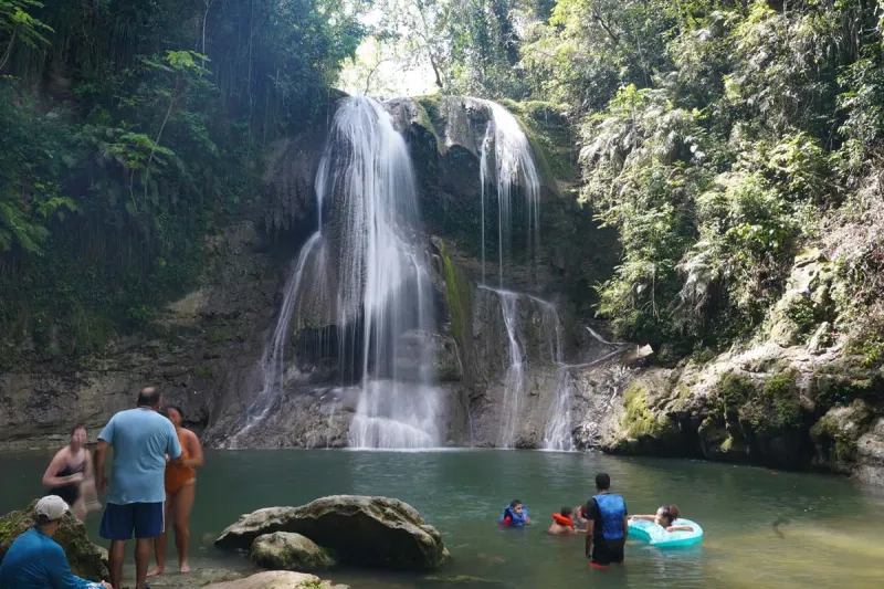 Waterfall and tropical beach on a 4-in-1 tour of Puerto Rico south coast hike and swim experience